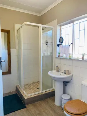a bathroom with a shower and a sink at Springbok 47 in Polokwane