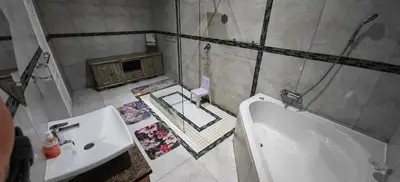 a bathroom with a tub and a sink and a bath tub at Marloth Birdhaven in Marloth Park