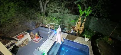 an overhead view of a swimming pool with an umbrella at Marloth Birdhaven in Marloth Park