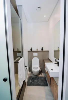 a bathroom with a toilet and a sink at The Hideaway at Menlyn Maine Trilogy in Pretoria