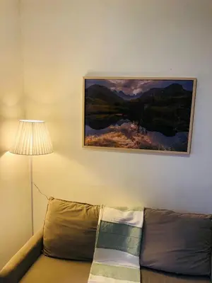 a couch in a living room with a painting on the wall at Apartment at the Blyde in Pretoria