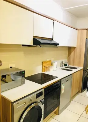 a kitchen with a washer and a dishwasher at Apartment at the Blyde in Pretoria