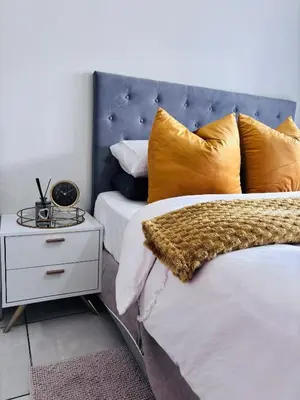 a bedroom with two beds with yellow pillows and a night stand at The Blyde Riverwalk Estate - Luxury Escape in Pretoria