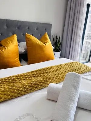 a bedroom with two beds with yellow pillows at The Blyde Riverwalk Estate - Luxury Escape in Pretoria