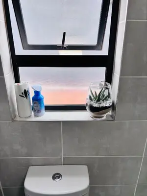 a bathroom with a window and a toilet in a bathroom at The Blyde Riverwalk Estate - Luxury Escape in Pretoria