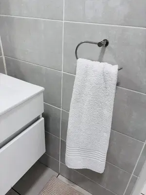 a white towel hanging on a towel rack in a bathroom at The Blyde Riverwalk Estate - Luxury Escape in Pretoria