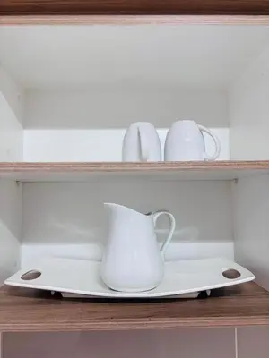 a shelf with two white pitchers and a vase on it at The Blyde Riverwalk Estate - Luxury Escape in Pretoria