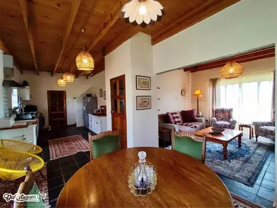 a large living room with a wooden table and chairs at Amber & Birch in Dullstroom