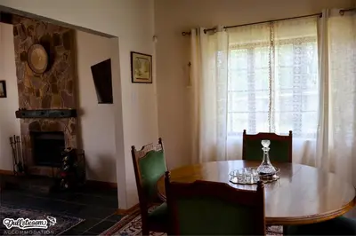 a dining room with a table and a fireplace at Amber & Birch in Dullstroom