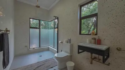 a bathroom with a sink and a toilet and a window at 2219 Kruger Wild in Marloth Park