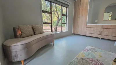 a living room with a couch and a window at 2219 Kruger Wild in Marloth Park