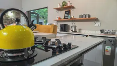 a yellow tea kettle on top of a stove in a kitchen at 2219 Kruger Wild in Marloth Park