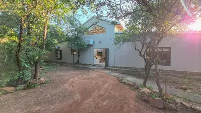 a house with a dirt road in front of it at 2219 Kruger Wild in Marloth Park