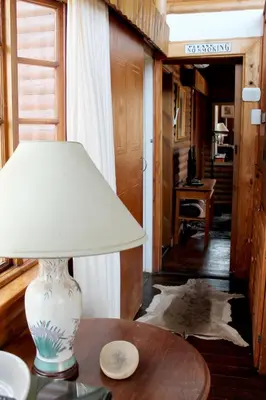 a lamp sitting on top of a table in a room at River Ridge Log Home - Inside Dinokeng Big 5 in Klipdrift