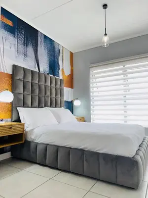 a large bed with a large headboard in a bedroom at Playa Azul in Pretoria