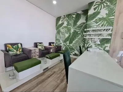 a living room with green plants on the wall at Playa Azul in Pretoria