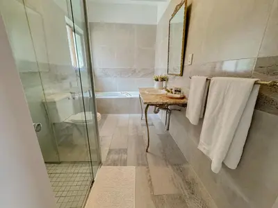 a bathroom with a shower and a sink and a toilet at Miyanwe Guest House - Waterkloof in Pretoria