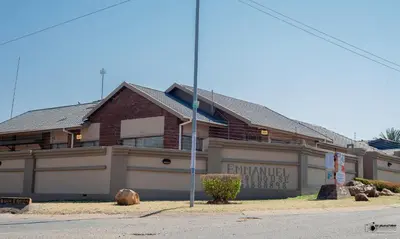 a house with a sign in front of it at Emmanuel Guesthouse in Witbank