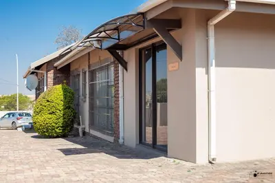 a building with awning on the side of it at Emmanuel Guesthouse in Witbank
