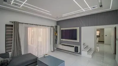 a living room with a couch and a tv at Away like Home in Midrand