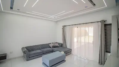 a living room with a couch and a window at Away like Home in Midrand