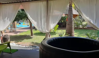 a view of a backyard with a pool and a tent at Hoogland Spa Resort Bela Bela in Bela-Bela