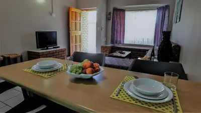 a dining room table with a bowl of fruit on it at Hoogland Spa Resort Bela Bela in Bela-Bela