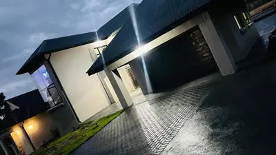 a house with the sun shining on the side of it at The Perazim Place at 222 Sabie River Eco-Estate in Hazyview