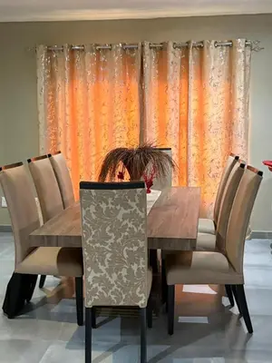 a woman sitting at a dining room table at The Perazim Place at 222 Sabie River Eco-Estate in Hazyview