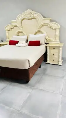 a bedroom with a large bed and a night stand at The Perazim Place at 222 Sabie River Eco-Estate in Hazyview