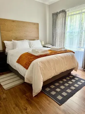 a bedroom with a large bed and a window at Marie Guest House in Polokwane
