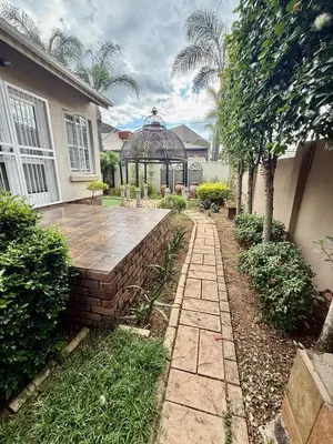 a garden with a gazebo in a house at Marie Guest House in Polokwane