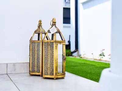 a gold lantern sitting on a sidewalk at C'est La Vie Guest House in Witbank