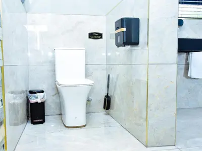a bathroom with a toilet and a trash can at C'est La Vie Guest House in Witbank