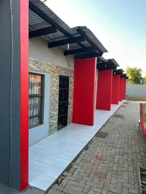 a row of red pillars on a building at Lakeboutiquehotel empire new in Thohoyandou