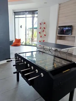 a ping pong table in a living room with a ping pong ball at kaso holidays at the Blyde in Pretoria