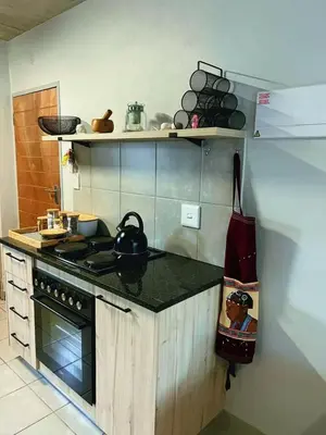 a kitchen with a stove and a tea kettle on the counter at Felinga Guest House in Centurion