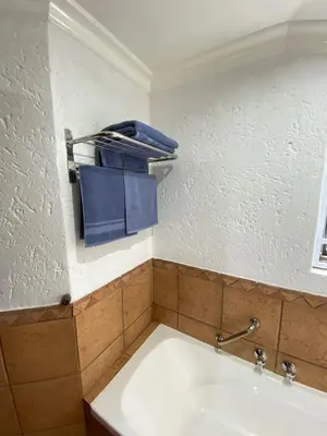 a bathroom with a white sink in a room at Glen Gory stay in Benoni