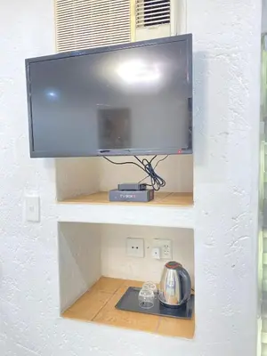 a flat screen tv hanging on a wall at Glen Gory stay in Benoni