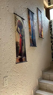 a wall with three pictures of a woman with an umbrella at Glen Gory stay in Benoni