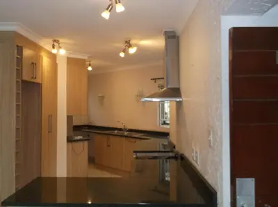 a large kitchen with a sink and a stove at Glen Gory stay in Benoni