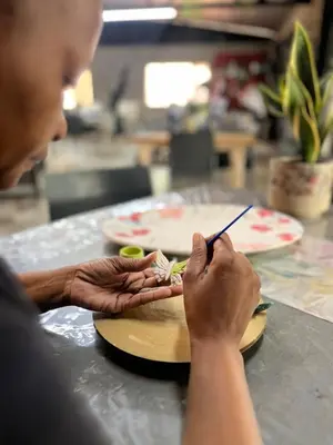 a man is preparing food on a table at Blessings is a home with Cozy Charms in Pretoria