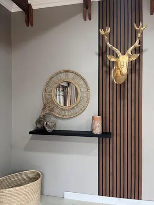 a mirror on a wall next to a shelf at Blessings is a home with Cozy Charms in Pretoria