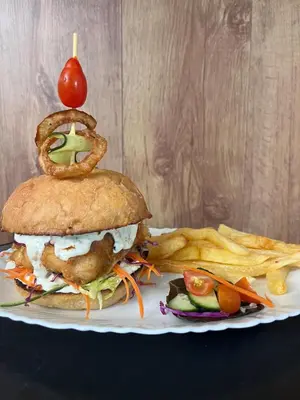 a sandwich and french fries on a plate at Blessings is a home with Cozy Charms in Pretoria