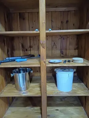 a wooden shelf with plates and utensils on it at Blessings is a home with Cozy Charms in Pretoria