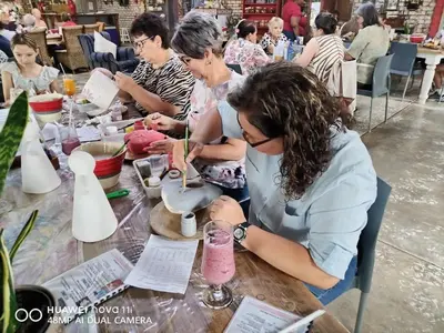 a group of people sitting at a table with a pink drink at Blessings is a home with Cozy Charms in Pretoria