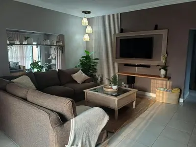 a living room with a couch and a tv at Blessings is a home with Cozy Charms in Pretoria