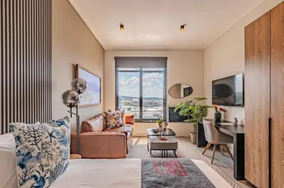 a living room with a couch and a table at Menlyn Maine in Pretoria