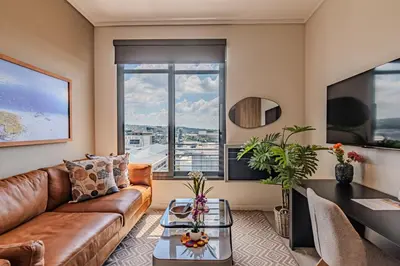 a living room with a couch and a table at Menlyn Maine in Pretoria