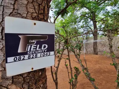 a sign on the side of a tree at Manor by My Adventure House in Marloth Park